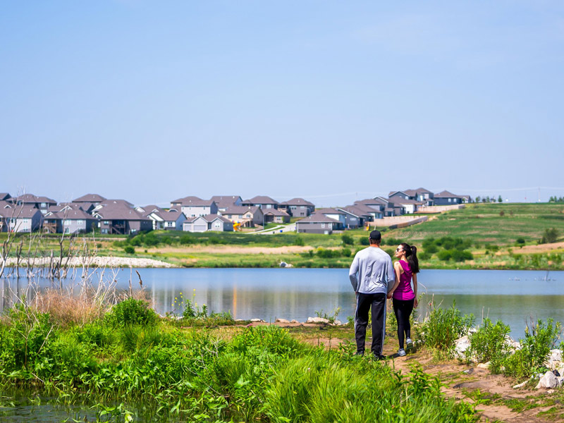 Couple on trail outside of Omaha community developed by The Land Company