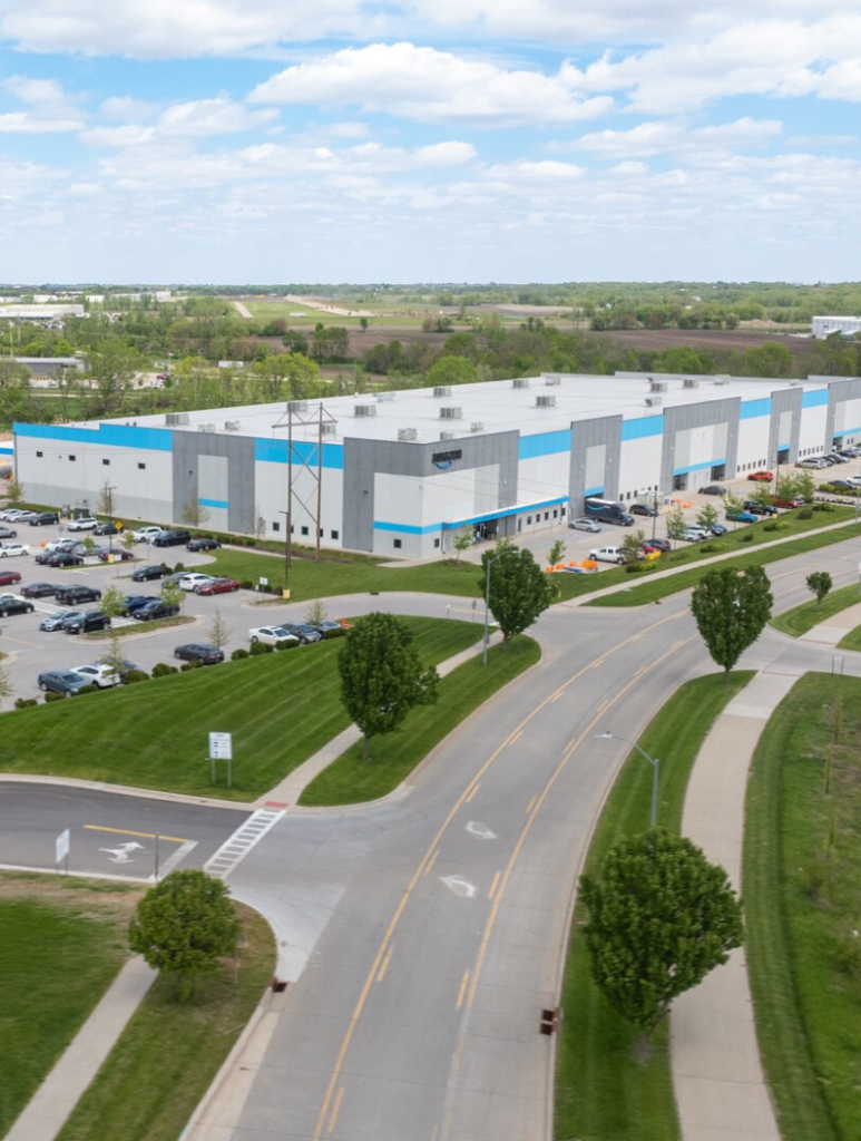 distribution warehouse with green grass and docking bays