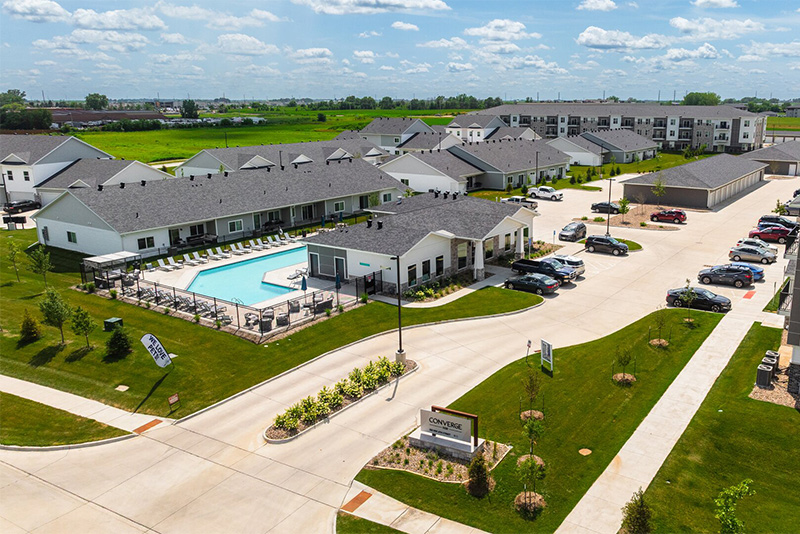 Aerial view of an Indigo Living apartment complex outdoor pool