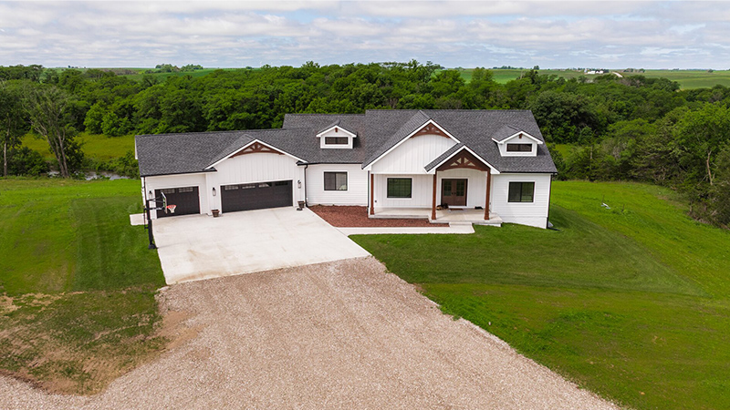 Exterior of a large white home in a rural area