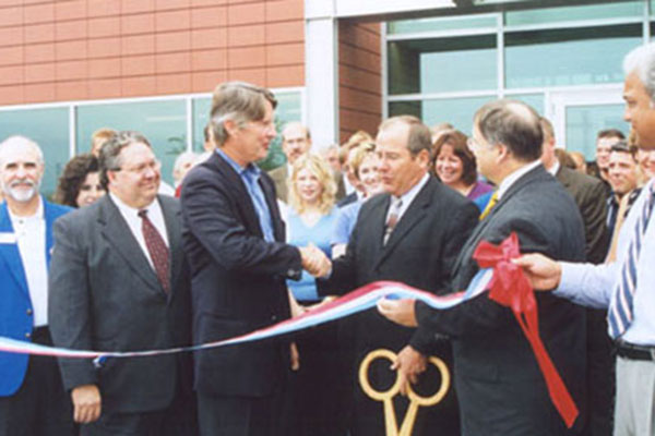 Hubbell new headquarters opening being celebrated by the Hubbell team cutting the ribbon in front of the new building.