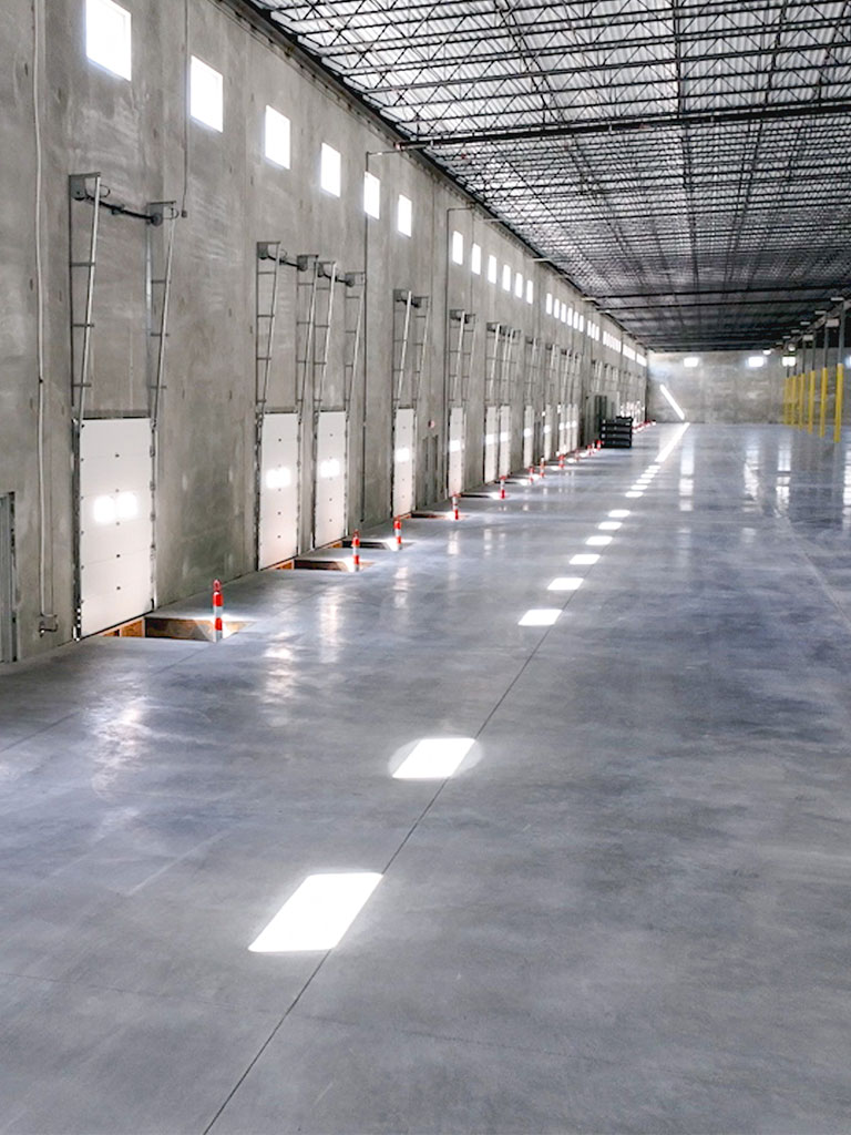 Aerial side view of the Hubbell Four Mile Distribution Center loading dock area with multiple dock doors and a large paved lot.