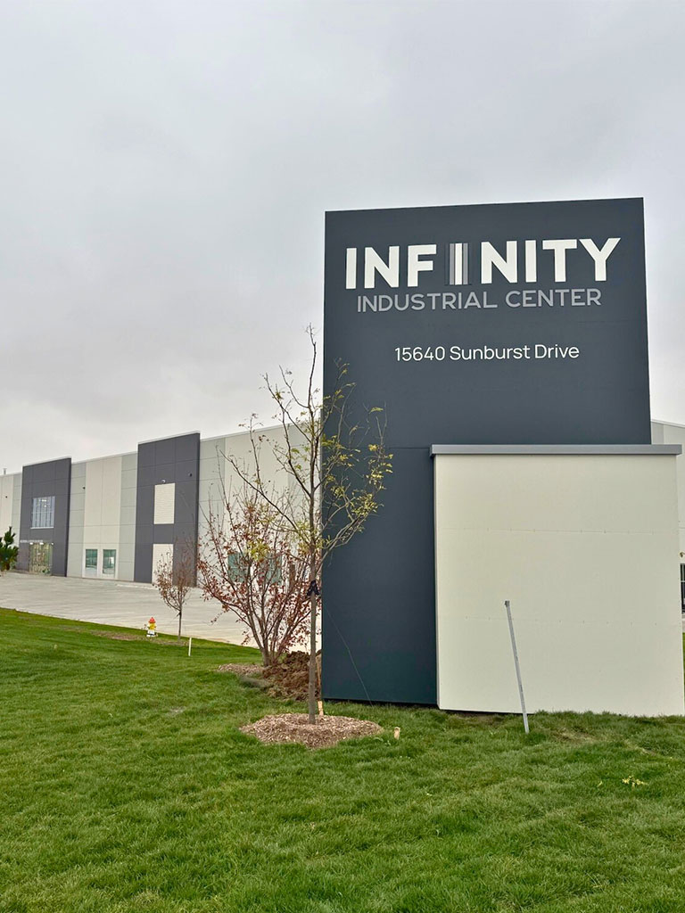 Front view of the Hubbell Infinity Industrial Center Building with prominent monument sign reading ‘Infinity Industrial Center, 15640 Sunburst Drive.’