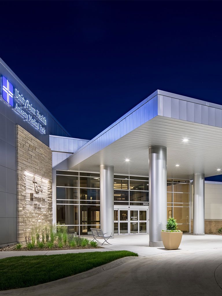 Exterior nighttime panorama of the Hubbell North Ankeny Medical Park showing the full medical facility, landscaped drive, and well‑lit entry.