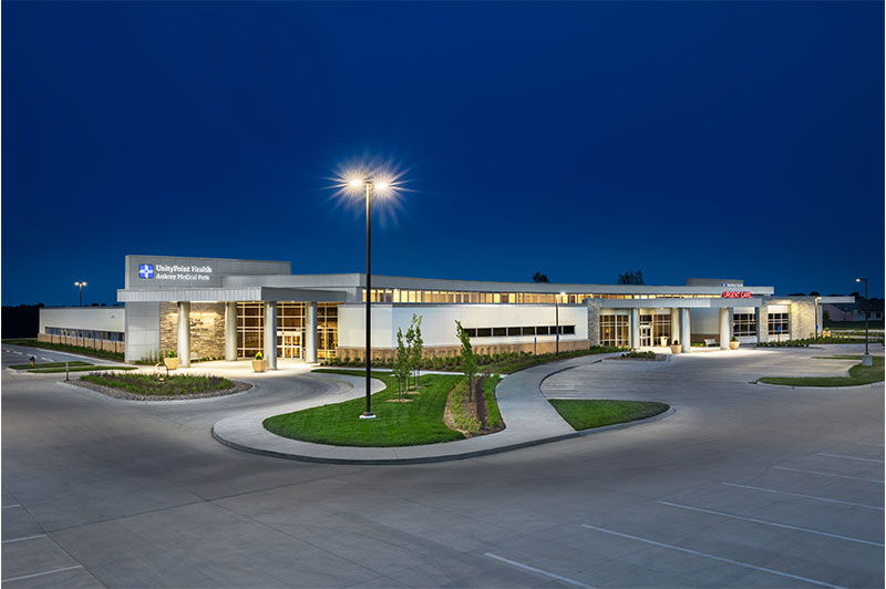 Close exterior shot of the entrance canopy at the Hubbell North Ankeny Medical Park with metal pillars and illuminated signage.