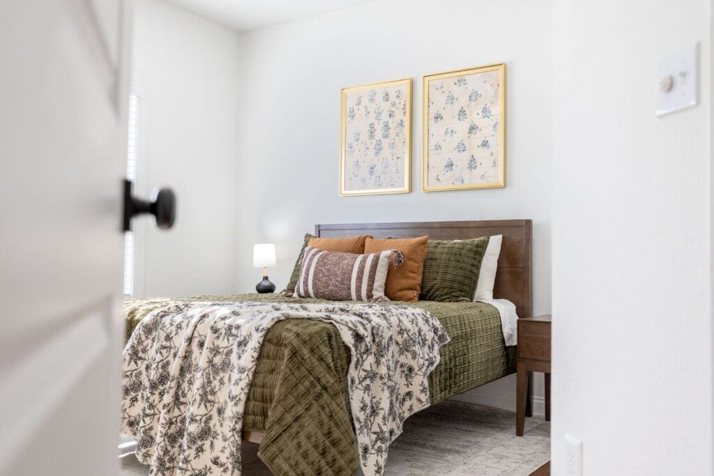 a bedroom with a green throw cover