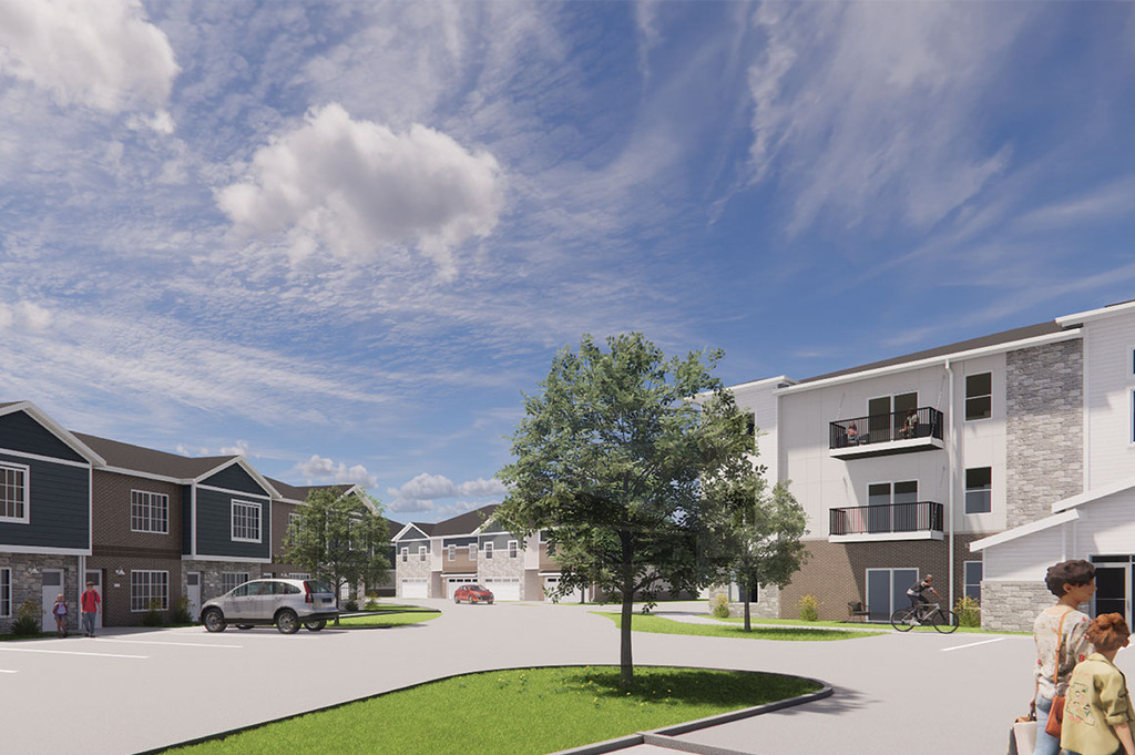 Rendering of a residential community (Sagebrook) with townhomes and low-rise apartments surrounding a central tree‑lined roadway and parking areas.